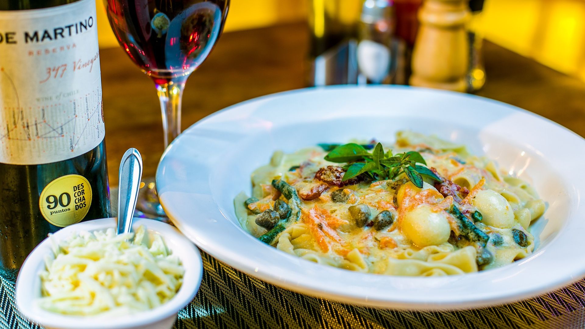 pasta meal with bottle of wine