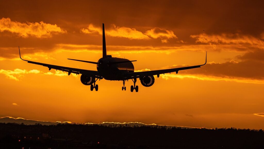 airplane landing at sunset
